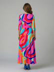 FJØRNA women's floral summer maxi dress with V-neck and wrap style, featuring a flowing silhouette and vibrant print.