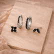 Unisex minimalist piercing set featuring stainless steel hoops and studs, stylish accessories for women by FJØRNA.