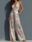 White floral satin halter neck jumpsuit for women with wrap front and wide-leg pants, by FJØRNA.