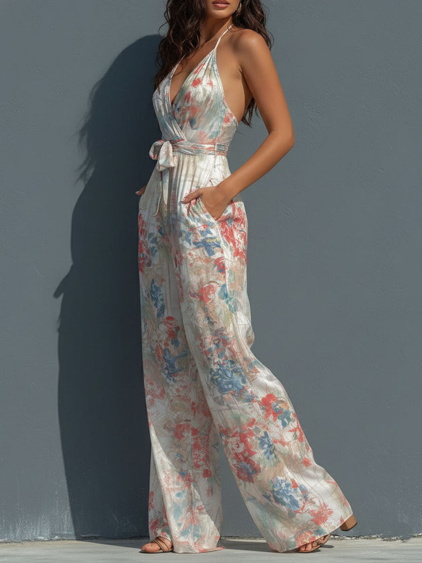 White floral satin halter neck wide-leg jumpsuit for women by FJØRNA, featuring a wrap front and stylish design.