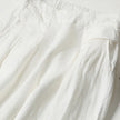 FJØRNA women's lightweight summer trousers with wide leg, high waist, and side pockets, shown in a casual pose.
