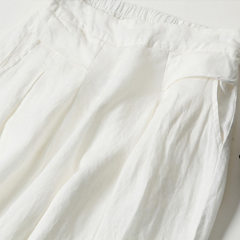 FJØRNA women's lightweight summer trousers with wide leg, high waist, and side pockets, shown in a casual pose.