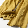 FJØRNA women's lightweight summer trousers with wide leg, high waist, and side pockets, made of breathable fabric.
