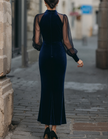 Navy blue velvet midi dress for women with mermaid silhouette and puff sleeves by FJØRNA, shown on a hanger.