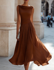 FJØRNA chiffon midi dress for women with draped neckline and pleated design, showcasing a flowing, elegant style.