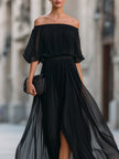 FJØRNA off-shoulder pleated chiffon maxi dress for wedding guests, flowing design with elegant off-shoulder style and pleated details.