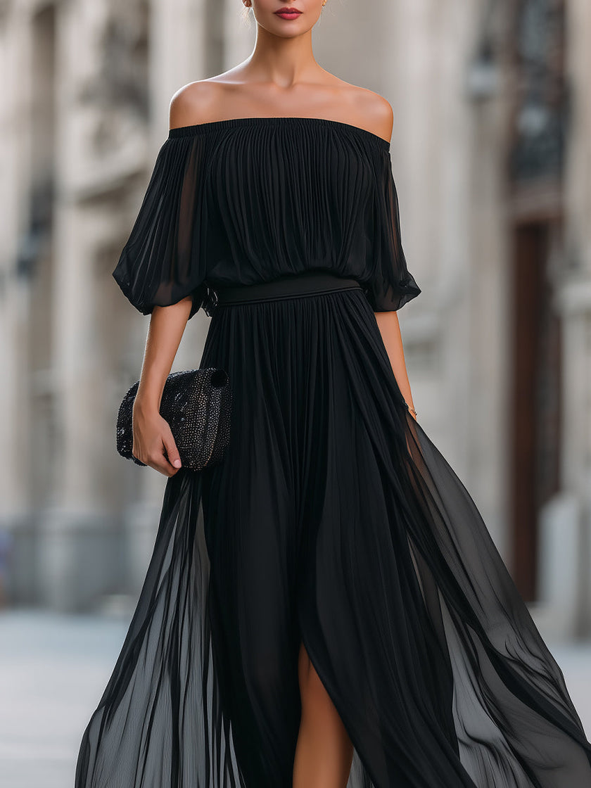 FJØRNA off-shoulder pleated chiffon maxi dress for wedding guests, flowing design with elegant off-shoulder style and pleated details.