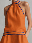 FJØRNA linen sleeveless mini dress in elegant design, perfect for evening occasions, shown in a stylish blue fabric.