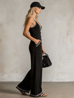 FJØRNA black color-block V-neck sleeveless jumpsuit with button-down front and pants design, stylish women's fashion outfit.