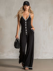 Black color-block V-neck sleeveless jumpsuit by FJØRNA, featuring button-down front and wide-leg pants for women.