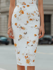 White floral FJØRNA deep V-neck bodycon midi dress featuring a fitted silhouette and elegant floral pattern.
