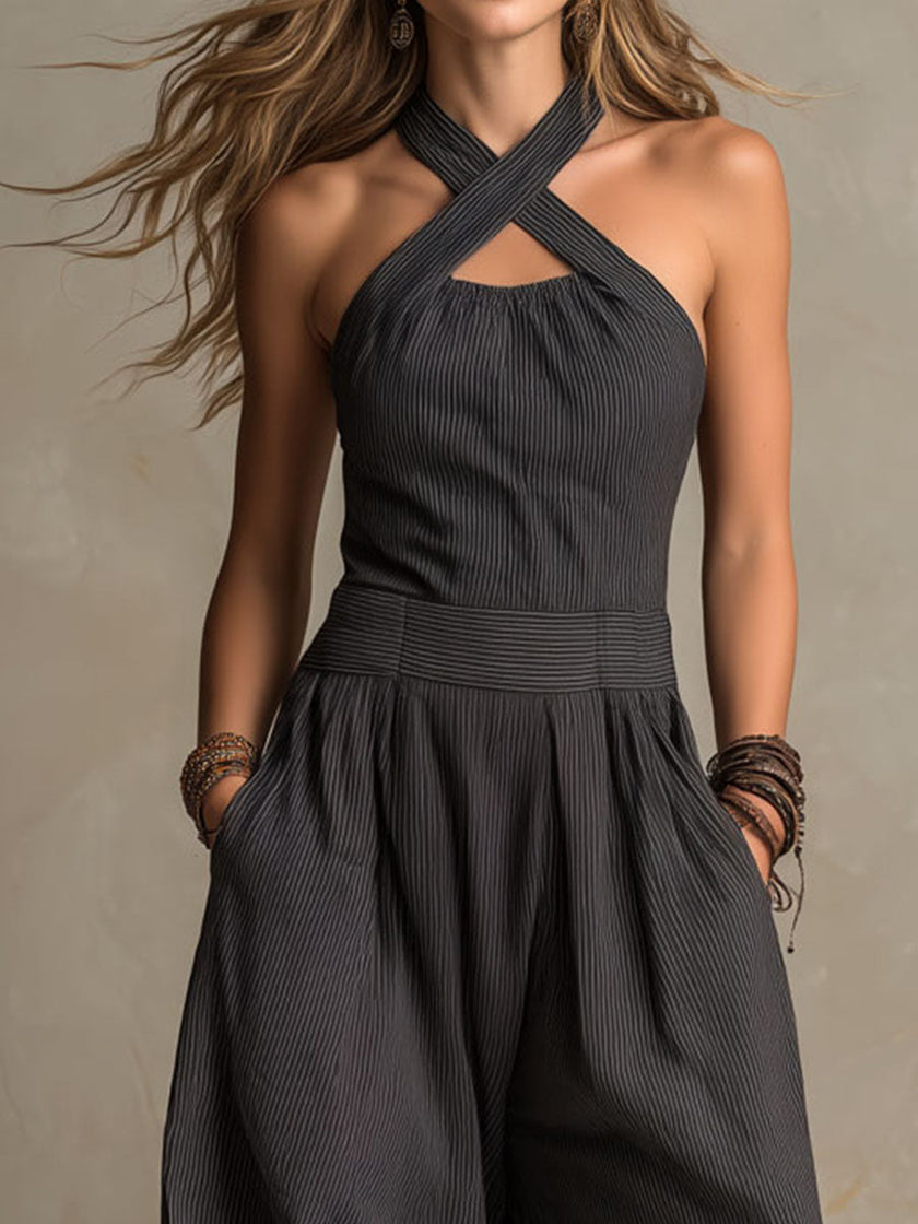 FJØRNA charcoal pinstripe halter neck wide-leg jumpsuit for women, showing the stylish halter top and flowing wide-leg pants.