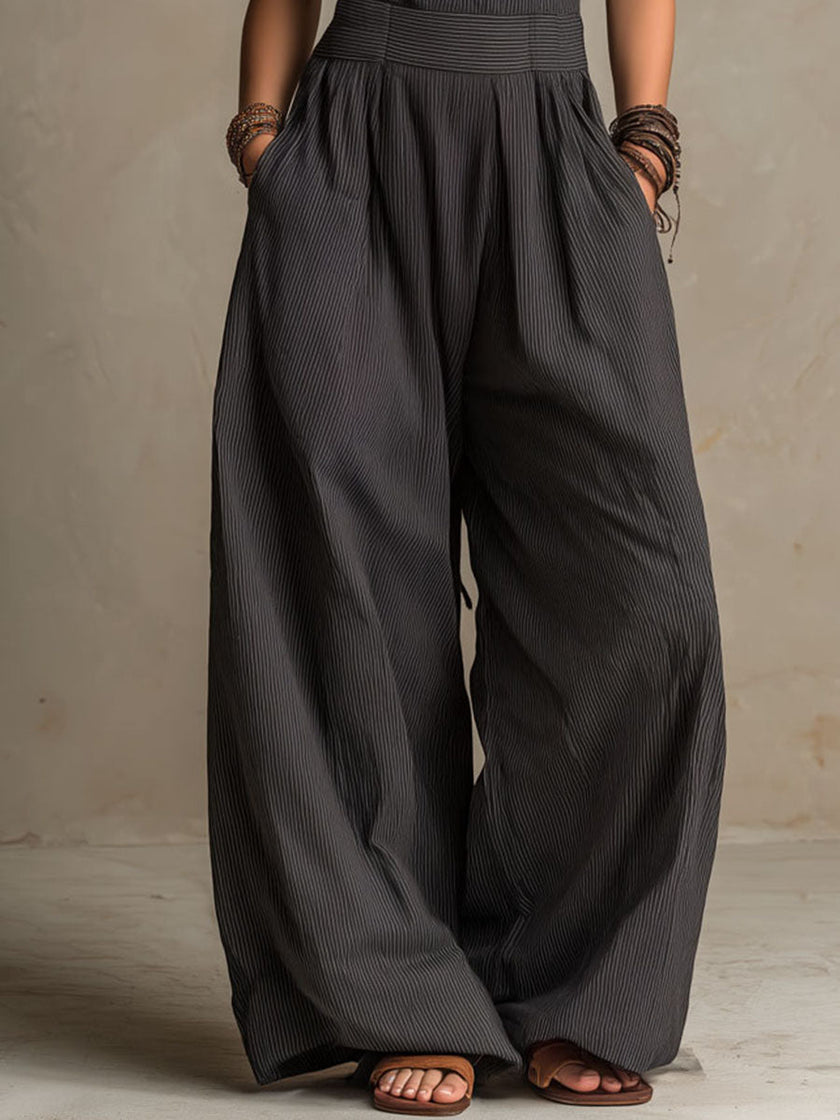 FJØRNA charcoal pinstripe halter neck wide-leg jumpsuit for women, stylish pants with a halter top and relaxed wide-leg fit.