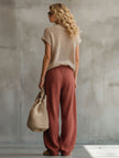 Brick red FJØRNA cotton linen wide-leg trousers for women, shown flat with relaxed fit and high waist detail.
