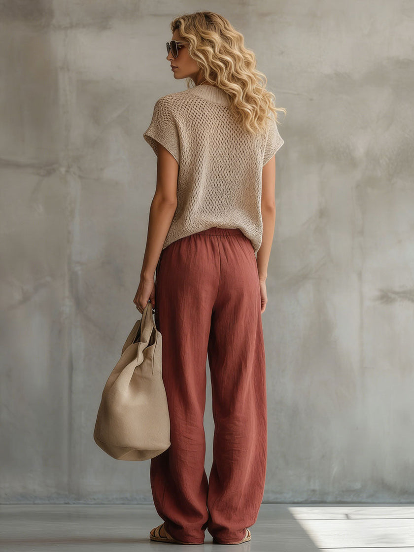 Brick red FJØRNA cotton linen wide-leg trousers for women, shown flat with relaxed fit and high waist detail.