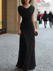 FJØRNA black draped cowl-neck ruched maxi dress displayed on a hanger, showcasing elegant fabric and flowing silhouette.