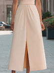 Beige sleeveless midi dress with lapel collar by FJØRNA, perfect for summer business attire, shown on a model.