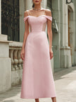 Elegant pink off-the-shoulder maxi dress by FJØRNA, flowing fabric with fitted bodice and ruffled sleeves, styled for summer occasions.