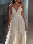 FJØRNA spaghetti-strap pleated flowing maxi dress, summer dress with lightweight fabric and elegant design, worn by a model.