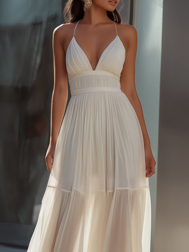 FJØRNA spaghetti-strap pleated flowing maxi dress, summer dress with lightweight fabric and elegant design, worn by a model.
