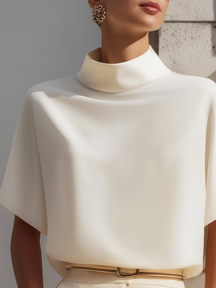 White high-neck minimalist blouse for women by FJØRNA, featuring draped design and elegant long sleeves.