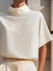 White high-neck draped minimalist blouse for women by FJØRNA, featuring a stylish and elegant design.