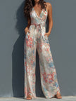 White floral satin halter neck jumpsuit with wrap front and wide-leg pants for women by FJØRNA.