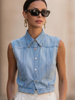 Light wash sleeveless denim vest from FJØRNA, women's button-down top with a casual, sleeveless design and classic denim texture.