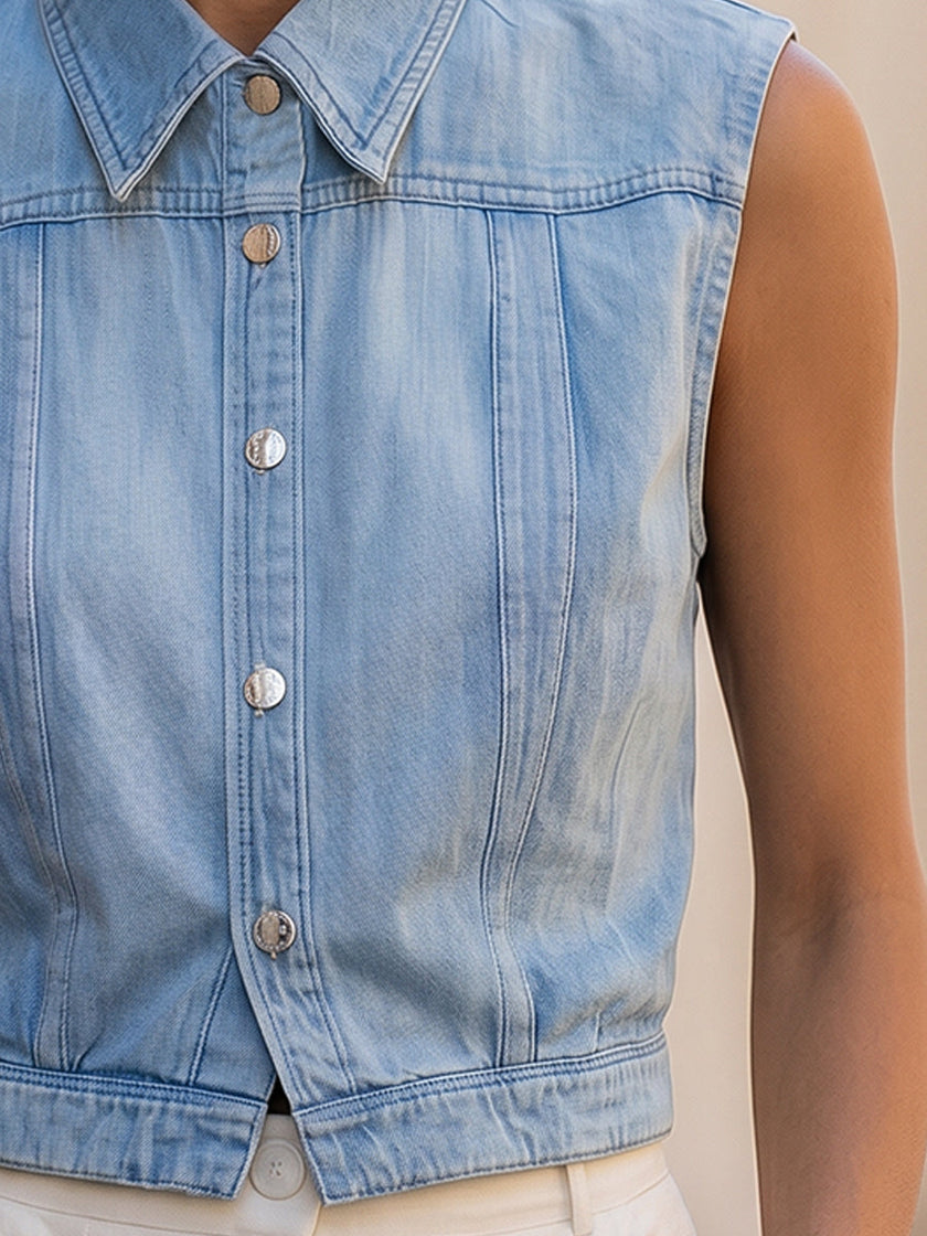 Light wash sleeveless denim vest from FJØRNA featuring button-down front and classic denim styling.