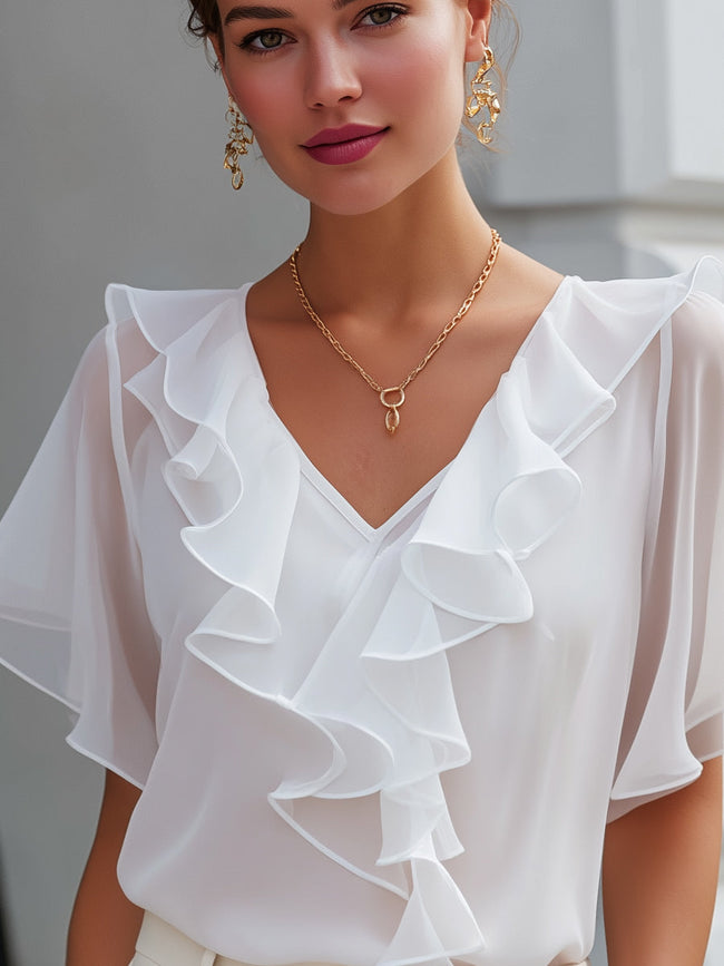 FJØRNA white v-neck sheer sleeve ruffle blouse for women, stylish lightweight top with elegant ruffle details and sheer sleeves.