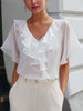 FJØRNA white v-neck sheer sleeve ruffle blouse for women, stylish top with delicate ruffle details and a lightweight, elegant design.