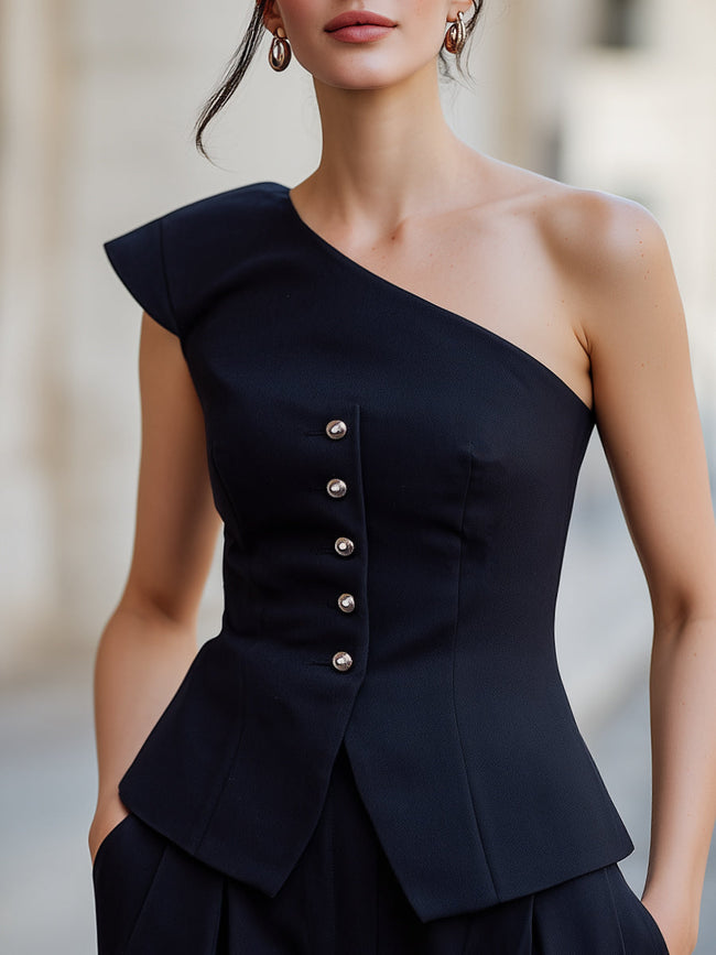 Navy blue FJØRNA women's one-shoulder peplum top with button details, structured fit, and elegant style.