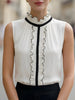 Ivory sleeveless ruffle high-neck blouse for women by FJØRNA, showcasing elegant ruffle details and a stylish high neckline.