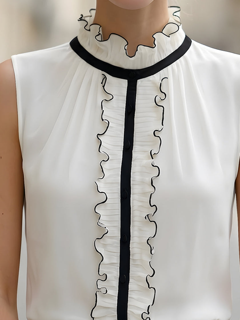 Ivory sleeveless ruffle high-neck blouse for women by FJØRNA, showcasing elegant ruffle details and a high neckline.