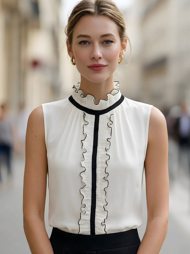 Ivory sleeveless ruffle high-neck blouse for women by FJØRNA, featuring a stylish white top with ruffle details.