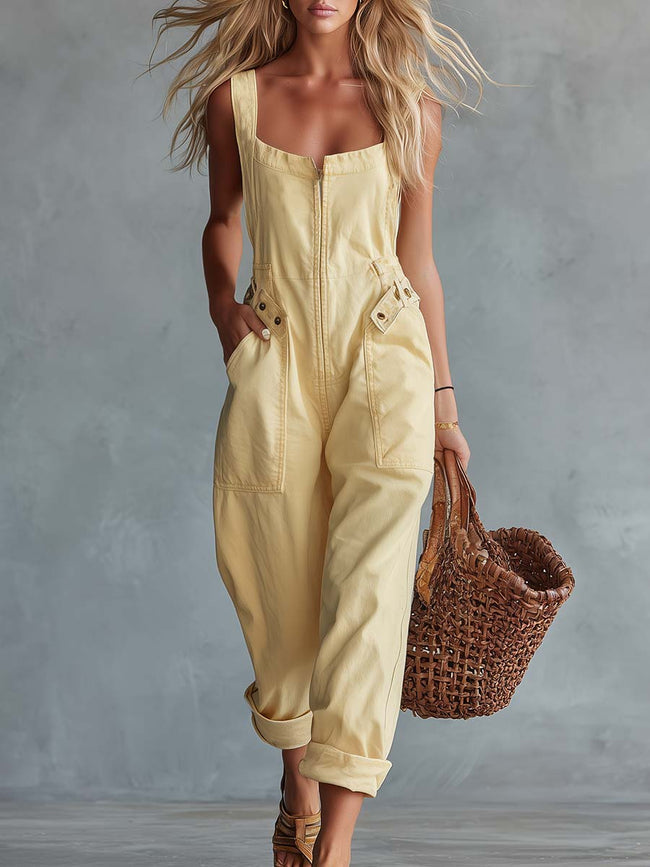 Light yellow denim jumpsuit by FJØRNA featuring a square neckline, zip-front closure, and women's pants style.