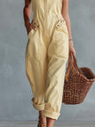Light yellow denim jumpsuit with square neck and zip-front, women's pants from FJØRNA featuring a stylish, casual design.