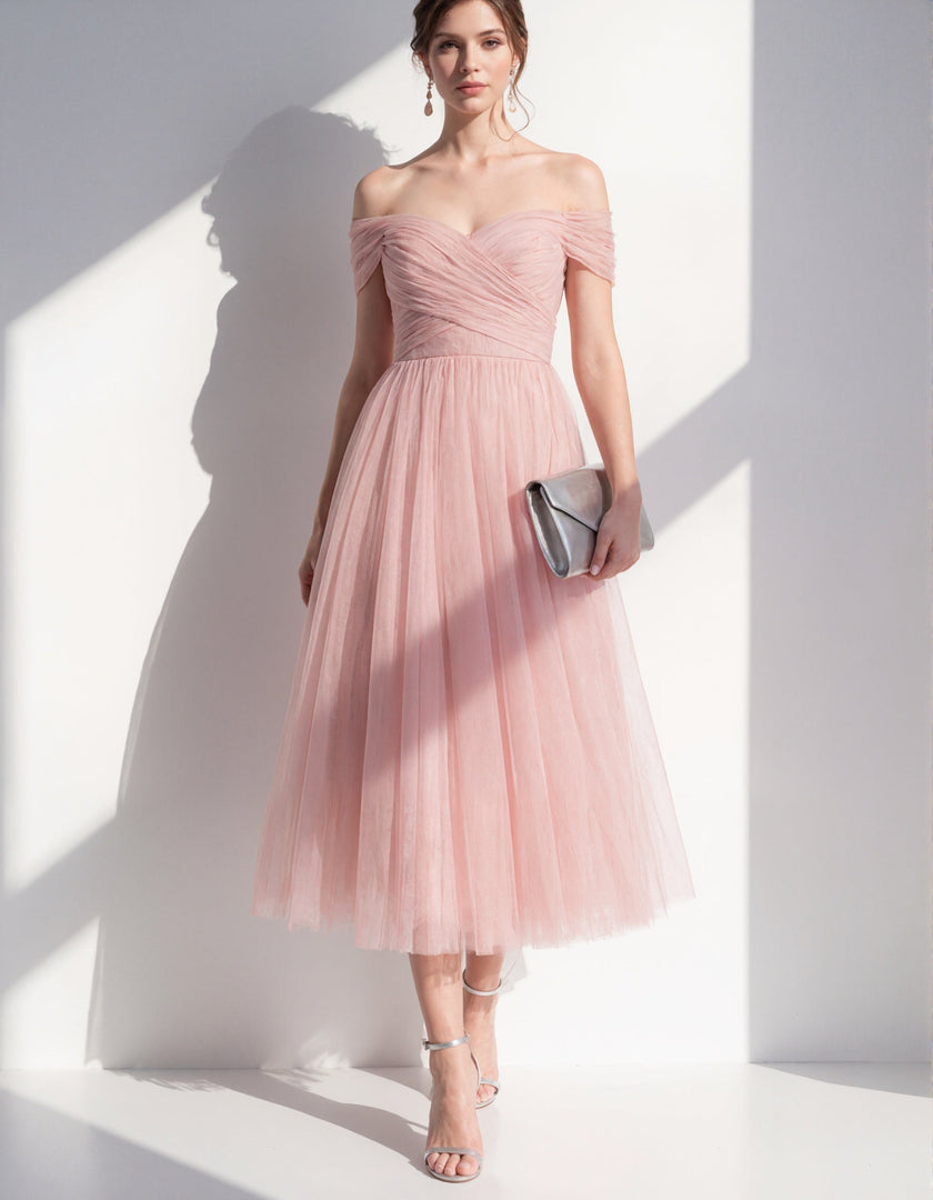 Pink tulle midi dress for women by FJØRNA, showcasing a flowing, elegant dress with a fitted waist and soft fabric detail.