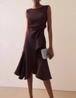 Pink FJØRNA midi dress for women with round neck, sleeveless design, ruffle and bow detail, perfect for elegant occasions.