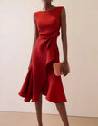 Pink FJØRNA midi dress for women with round neck, sleeveless design, ruffle and bow details, perfect for stylish occasions.
