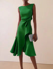 Pink FJØRNA midi dress for women with round neck, sleeveless design, ruffle and bow details, perfect for summer occasions.