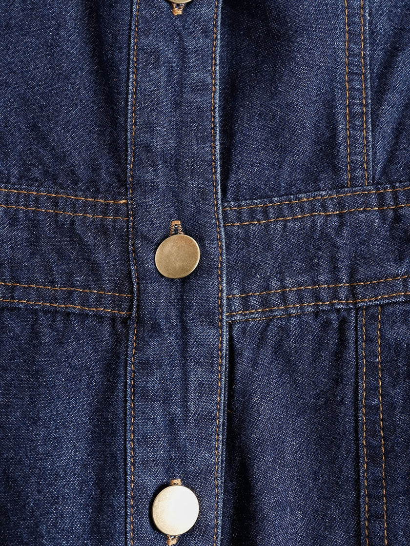 Dark blue denim FJØRNA women's sleeveless balloon jumpsuit with multi-pocket design and relaxed pant style.