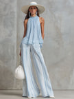 Light blue striped chiffon wide-leg women's pants by FJØRNA, featuring flowing fabric and relaxed fit.