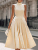 Cream sleeveless turtleneck pleated midi dress by FJØRNA, elegant wedding guest dress with flowy pleats and a fitted silhouette.