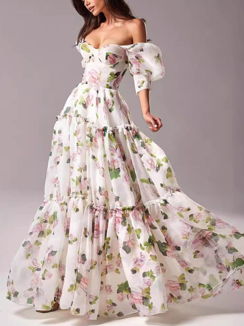 Elegant off-shoulder printed organza evening gown by FJØRNA, featuring a flowing maxi dress with floral patterns and a sophisticated design.