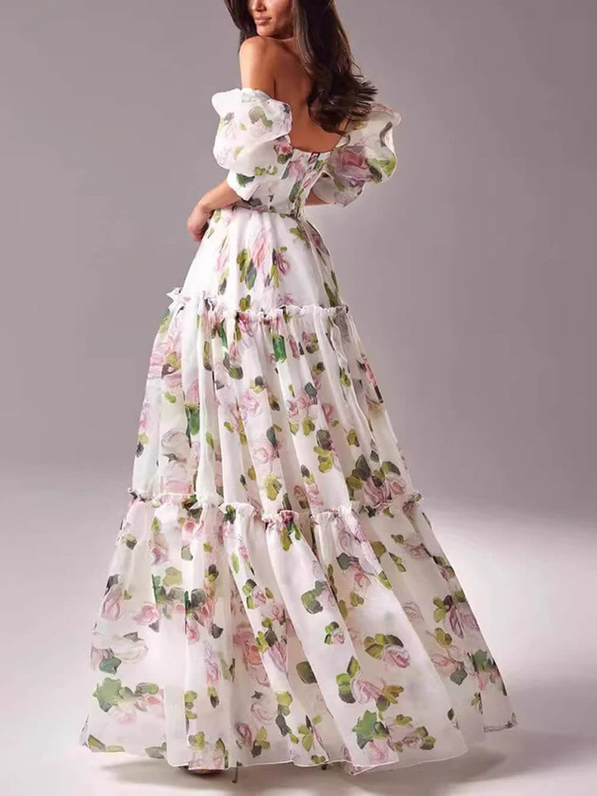 Elegant off-shoulder printed organza evening gown by FJØRNA featuring a flowing maxi dress with floral print and fitted bodice.