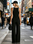 FJØRNA black color-block V-neck sleeveless jumpsuit with button-down front, fitted waist, and wide-leg pants for women.