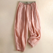 FJØRNA women's linen tapered trousers, light-colored pants with a relaxed fit, displayed on a neutral background.