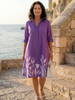 FJØRNA elegant women's dress with floral pattern and pockets, showcasing a flowy design and stylish details.