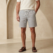 Men's striped relaxed shorts from FJØRNA with drawstring waist, casual summer design, featuring blue and white horizontal stripes.